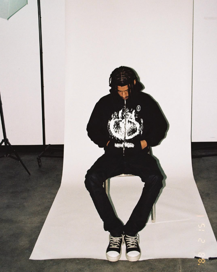 Twotone model sitting down with a twotone jacket